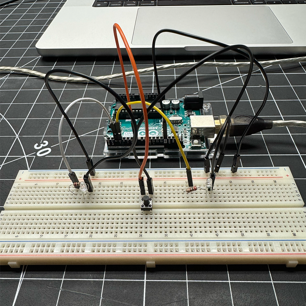 In this image we added a button to the circuit and edited the code (BUTTON_PIN 7) to have the LEDs turn on and off when the button is pressed.