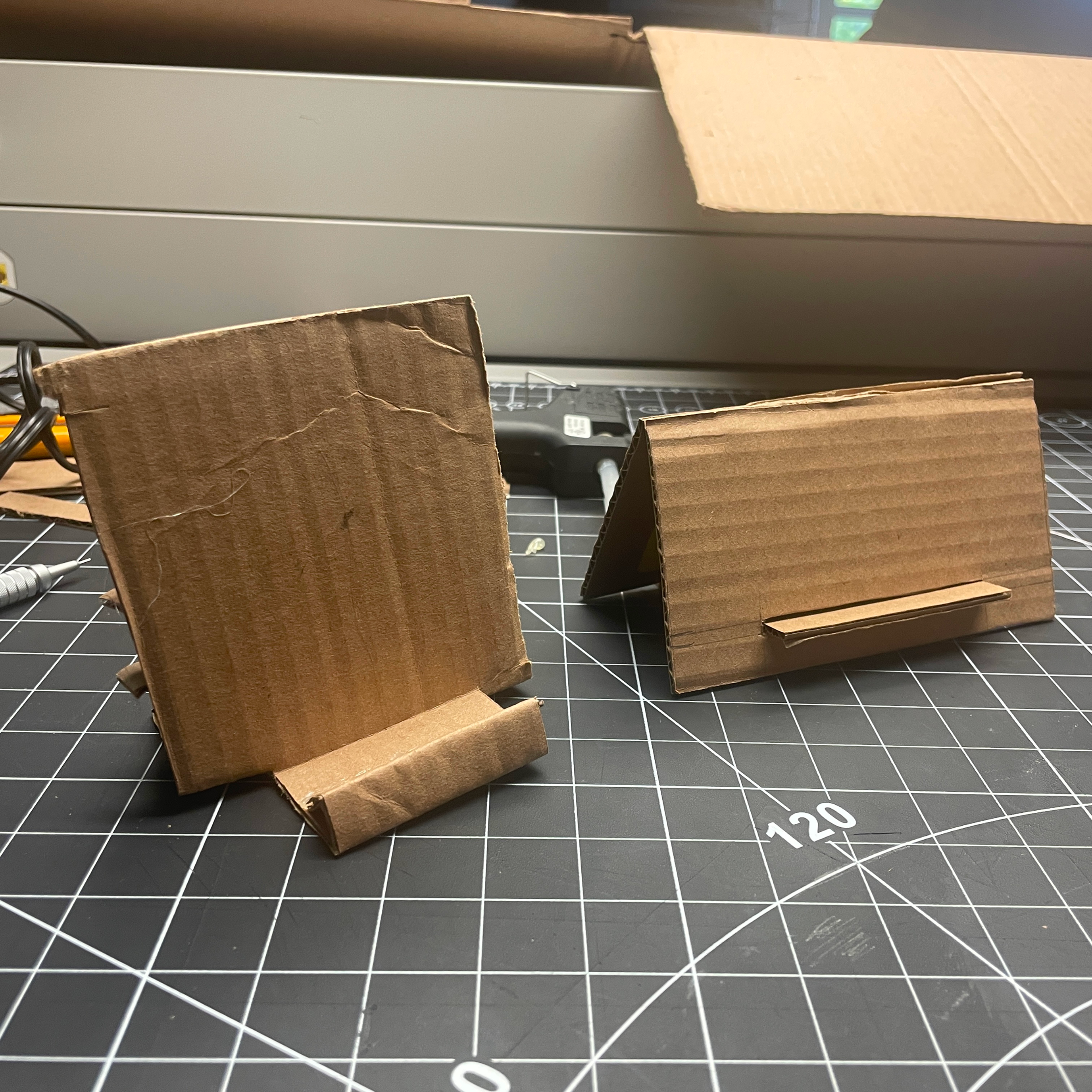 The next step of the activity was to iterate and improve upon the initial design of the phone stand. On the right is the phone stand made by the tutorial and on the left is the improved iteration of the stand.