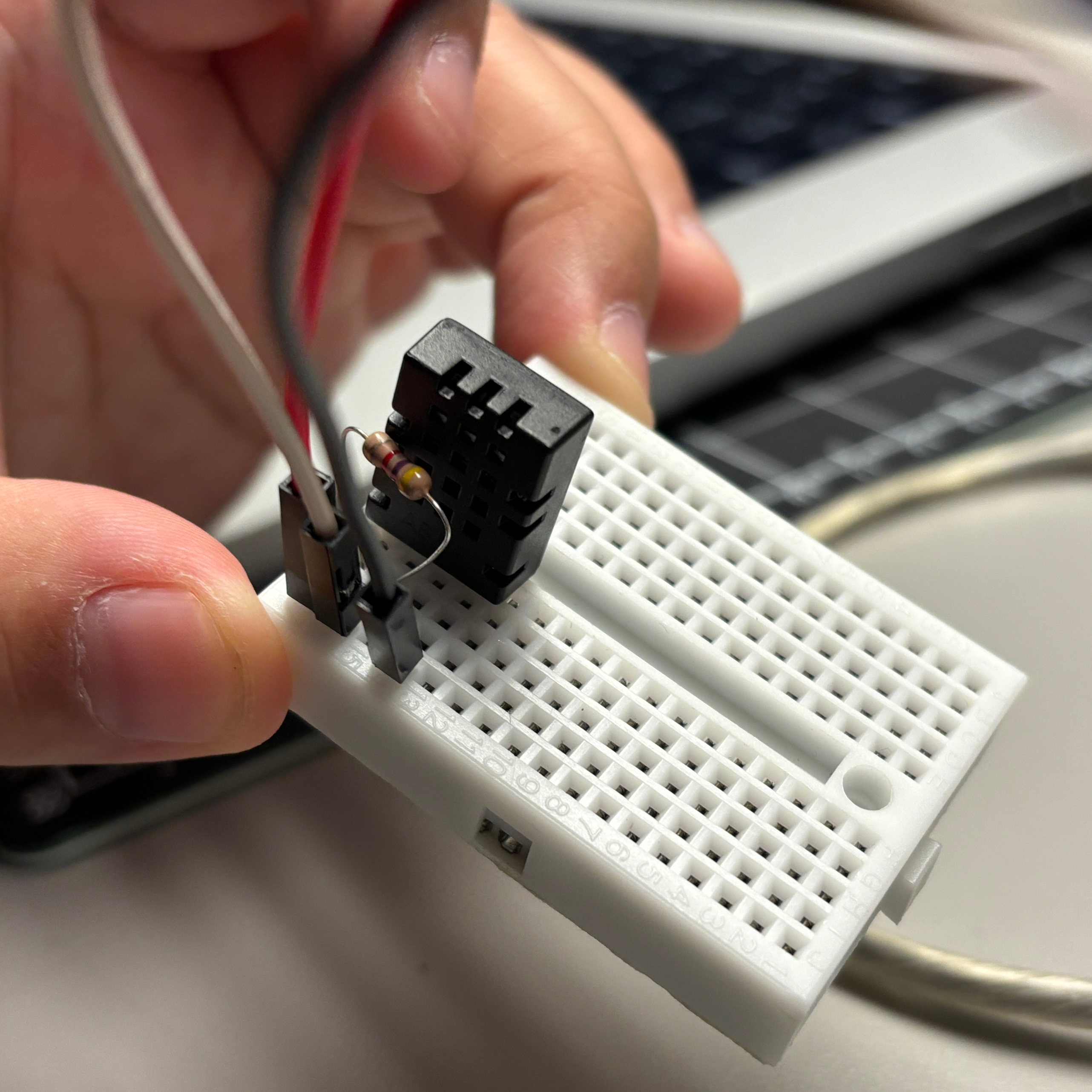 This is an up close image of our DHT20 sensor wired to the breadboard with the additional 4.7k ohm resistor between the data and power pins.